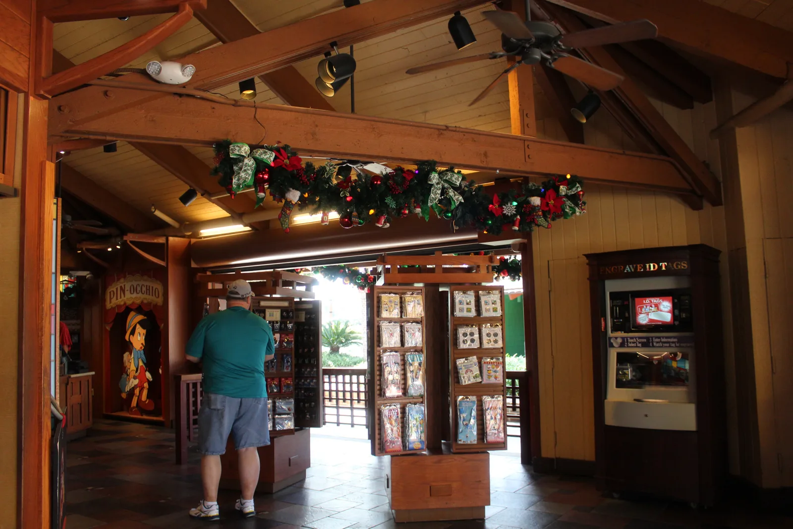 Wooden racks of pins and lanyards inside Disney’s Pin Traders.