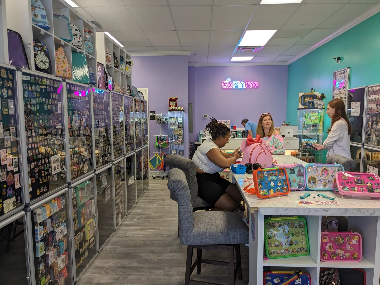 Collectors gathered among glass cases and colorful pin bags inside GoPinPro in Orlando.