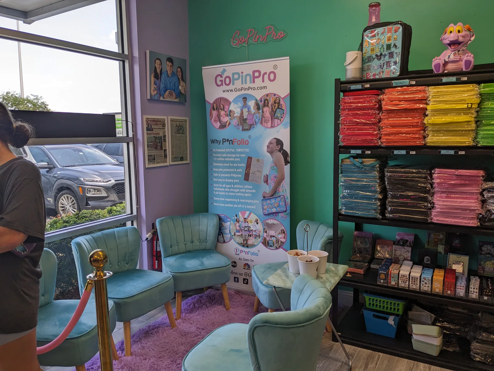 A seating area and shelves of colorful pin-storage bags at GoPinPro.