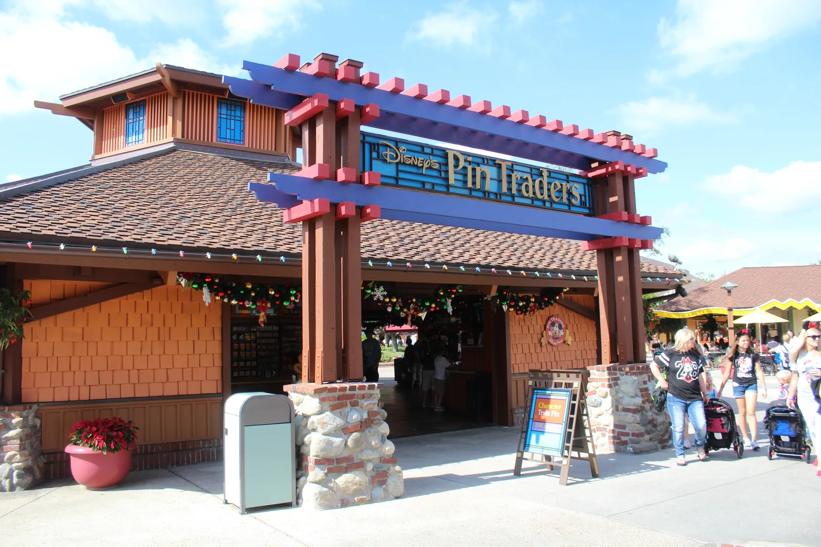 The orange and blue exterior of Disney’s Pin Traders at Disney Springs.